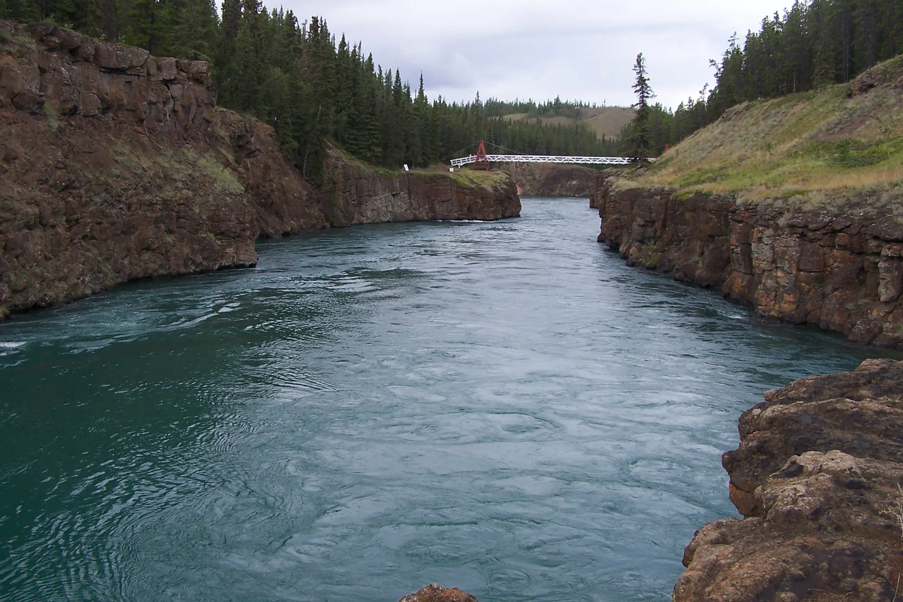 Turquoise Yukon River water flowing through Miles Canyon